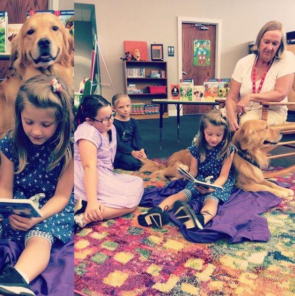 Carl, the therapy dog, and friends reading together.