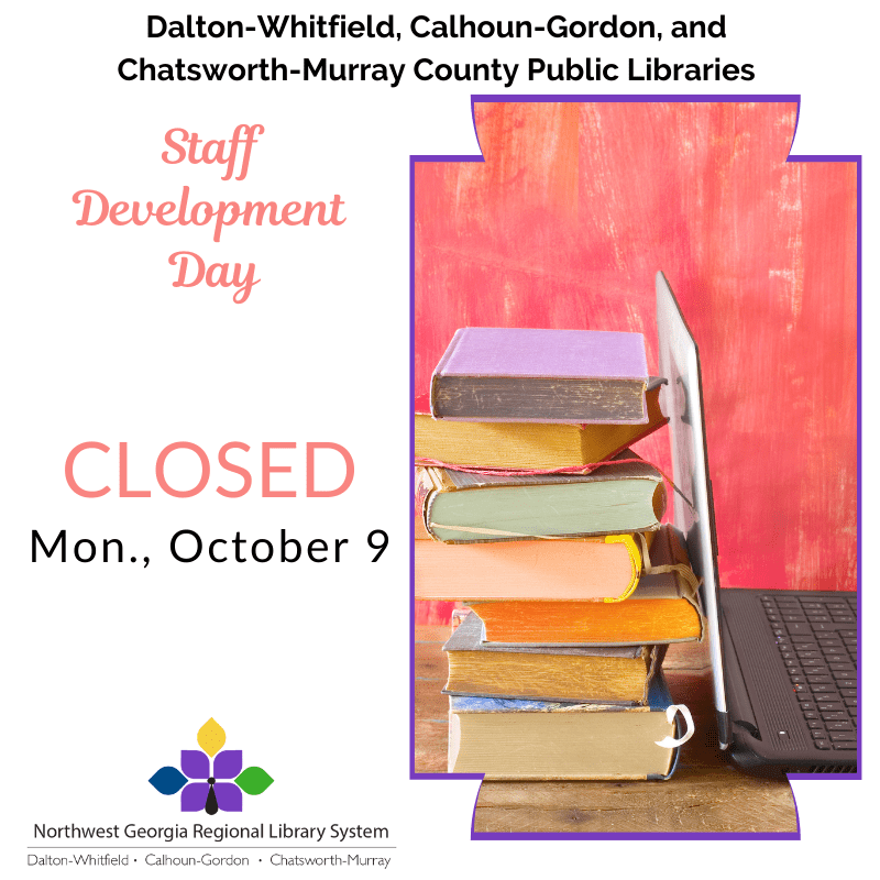 Books stacked with a laptop open against them.