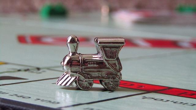 Silver train token on a board game surface.