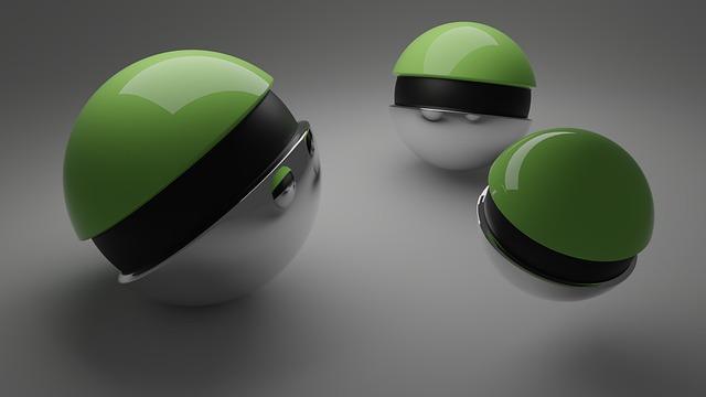 Three metallic spheres with green caps on a gray background.