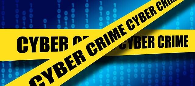 Yellow caution tape with "Cyber Crime" over digital binary background.