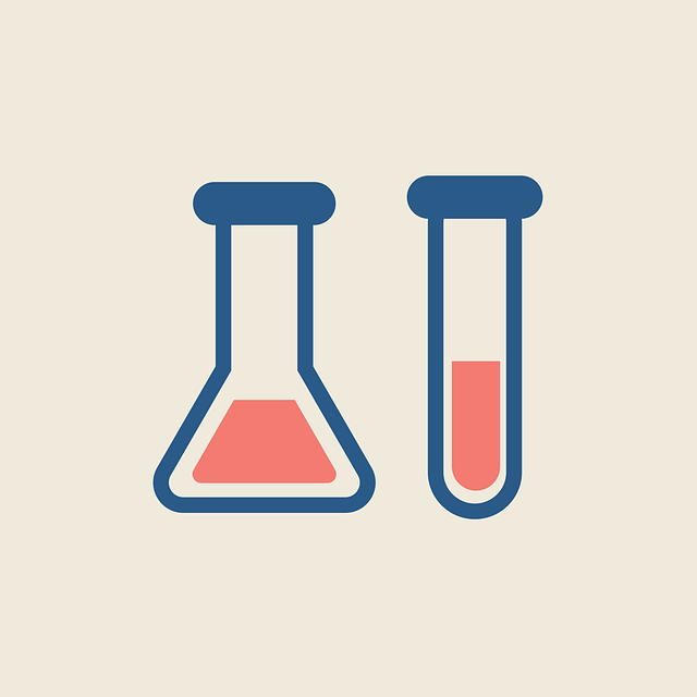 Laboratory flask and test tube filled with pink liquid on a beige background.