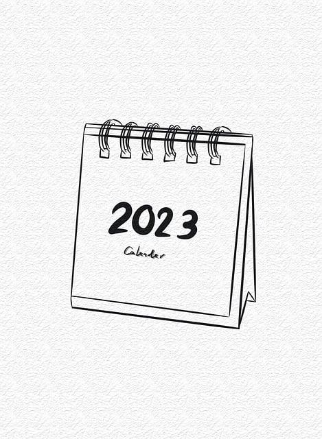 2023 desk calendar with spiral binding on a textured background.