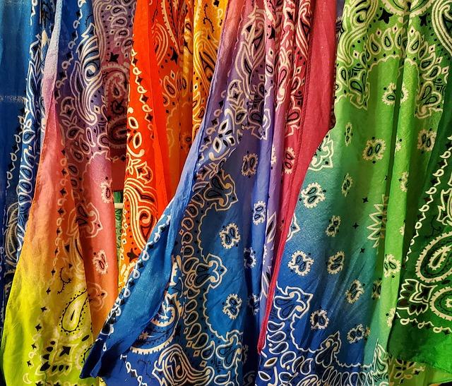 Colorful bandanas with intricate patterns hanging side by side.